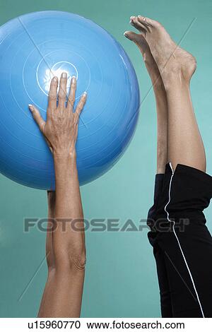 Mature woman exercising with Swiss ball (close-up) View Large Photo Image Stock Image - Mature woman exercising with Swiss ball (close-up). Fotosearch