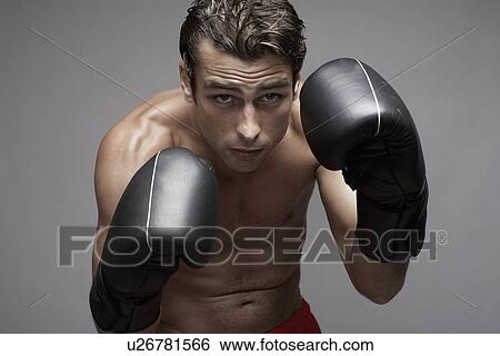 Stock Photograph - Mid adult man in boxing stance. Fotosearch