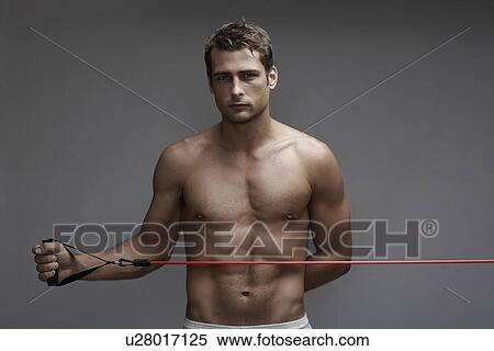 Mid adult man weight training with cable View Large Photo Image Stock Photography - Mid adult man weight training with cable. Fotosearch