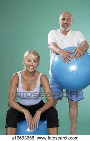 Senior man and mature woman with Swiss balls View Large Photo Image Stock Photo - Senior man and mature woman with Swiss balls. Fotosearch