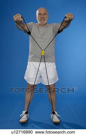 Stock Image - Senior man exercising with resistance band. Fotosearch
