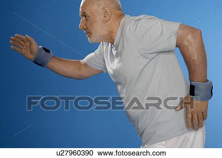 Senior man exercising with wrist weights View Large Photo Image Stock Image - Senior man exercising with wrist weights. Fotosearch