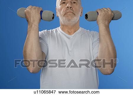 Senior man training with dumbbells View Large Photo Image Stock Photo - Senior man training with dumbbells. Fotosearch
