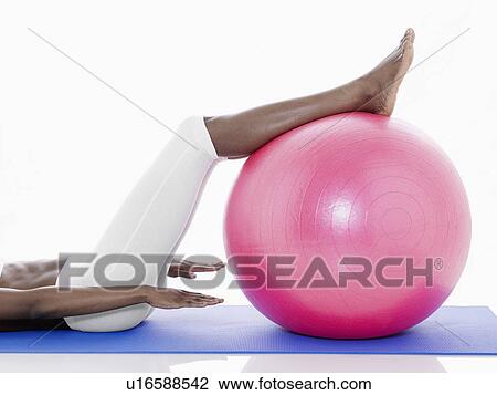 Woman exercising on fitness ball (low section) View Large Photo Image Stock Image - Woman exercising on fitness ball (low section). Fotosearch