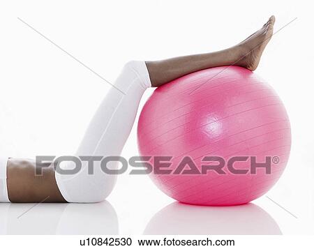 Woman exercising with Swiss ball (low section) View Large Photo Image Stock Image - Woman exercising with Swiss ball (low section). Fotosearch