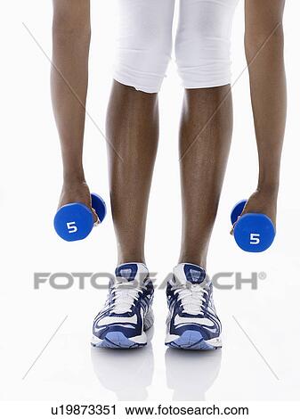 Woman lifting dumbbells (low section) View Large Photo Image Stock Image - Woman lifting dumbbells (low section). Fotosearch