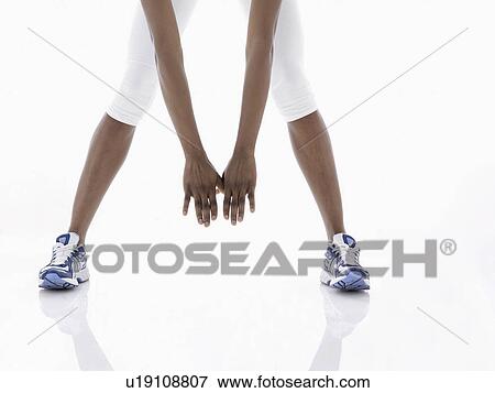 Woman stretching legs (low angle view) View Large Photo Image Stock Photo - Woman stretching legs (low angle view). Fotosearch
