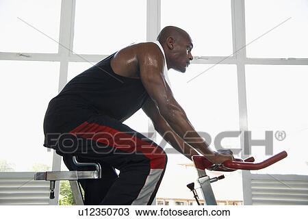 Man indoor cycling (low angle view) View Large Photo Image Stock Image - Man indoor cycling (low angle view). Fotosearch