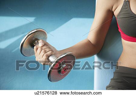 Woman lifting dumbbells (close-up) View Large Photo Image Stock Photo - Woman lifting dumbbells (close-up). Fotosearch