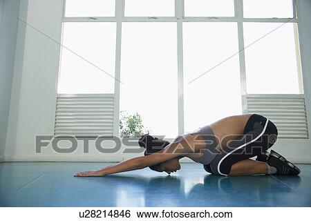 Woman stretching on floor View Large Photo Image Stock Photograph - Woman stretching on floor. Fotosearch