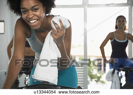 Young woman indoor cycling View Large Photo Image Picture - Young woman indoor cycling. Fotosearch