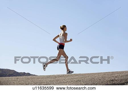 Young woman jogging View Large Photo Image Stock Photo - Young woman jogging. Fotosearch