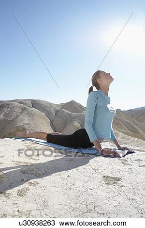 Young woman stretching in desert View Large Photo Image Stock Image - Young woman stretching in desert. Fotosearch