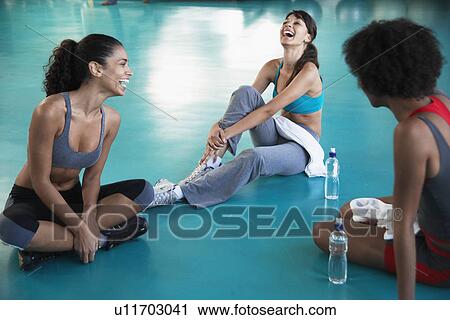 Stock Image - Young women in sports clothing laughing. Fotosearch