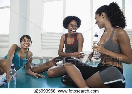 Young women in sports clothing talking View Large Photo Image Stock Photo - Young women in sports clothing talking. Fotosearch