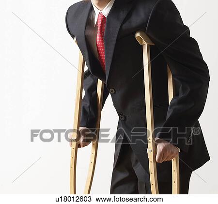 Businessman on Crutches View Large Photo Image Stock Image - Businessman on Crutches. Fotosearch