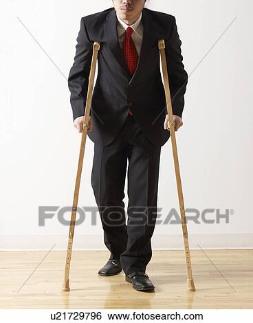 Stock Photograph - Businessman on Crutches. Fotosearch