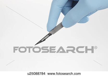 Hand holding scalpel (close-up) View Large Photo Image Picture - Hand holding scalpel (close-up). Fotosearch