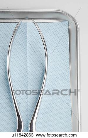 Stock Image - Medical instrument in stainless steel tray (close-up). Fotosearch