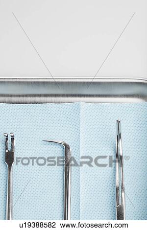 Stock Image - Medical instruments on tray (close-up). Fotosearch