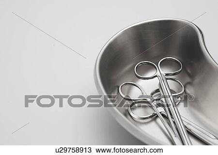 Stock Image - Medical scissors in kidney dish. Fotosearch
