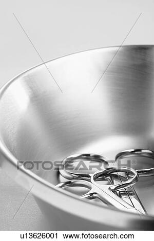 Stock Image - Medical scissors in stainless steel bowl. Fotosearch