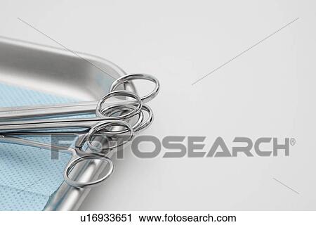 Stock Image - Medical scissors on metal tray (close-up). Fotosearch