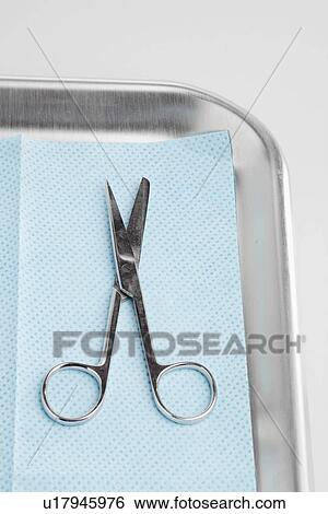 Stock Photograph - Medical scissors on tray. Fotosearch