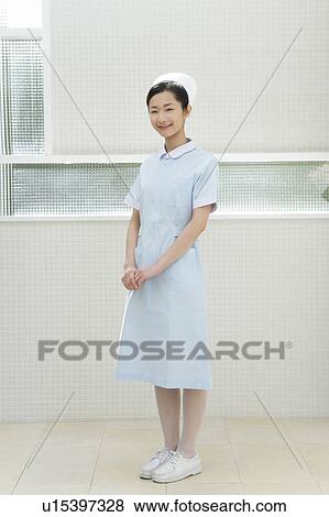 Portrait of a nurse, smiling and looking at camera, front view View Large Photo Image Stock Photo - Portrait of a nurse, smiling and looking at camera, front view. Fotosearch
