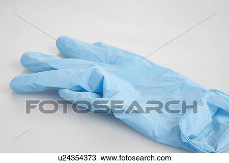 Stock Image - Single rubber glove (close-up). Fotosearch