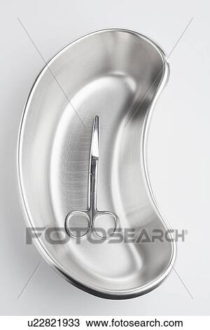 Stock Image - Surgical scissors in kidney dish. Fotosearch