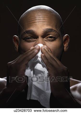 Young man blowing nose View Large Photo Image Stock Image - Young man blowing nose. Fotosearch