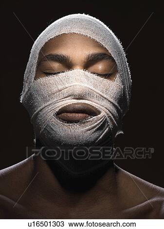 Stock Image - Young man with bandage around head. Fotosearch