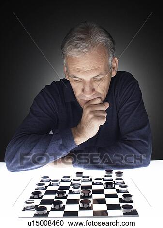Man playing checkers View Large Photo Image Stock Image - Man playing checkers. Fotosearch