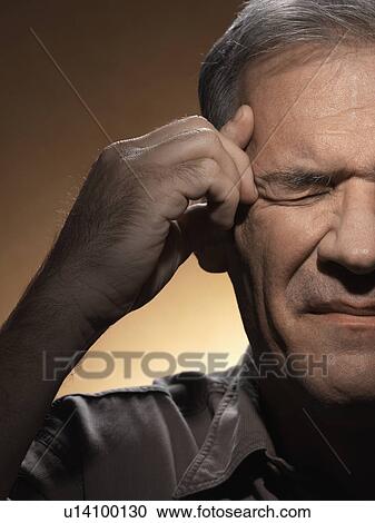 Man rubbing forehead View Large Photo Image Stock Image - Man rubbing forehead. Fotosearch