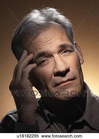 Mature man rubbing forehead View Large Photo Image Stock Photography - Mature man rubbing forehead. Fotosearch