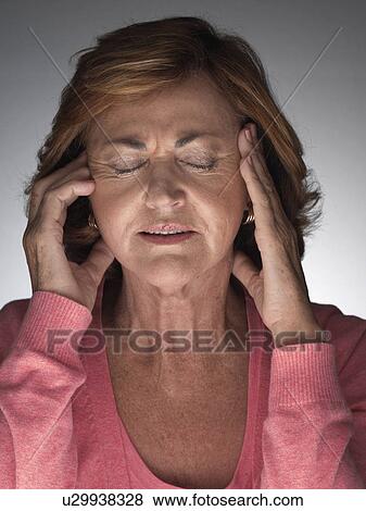 Stock Photo - Mature woman with headache. Fotosearch