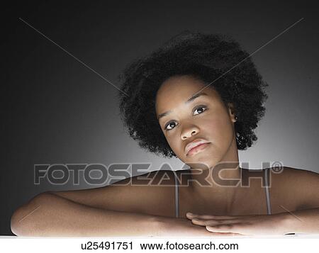 Stock Image - Pensive young woman (portrait). Fotosearch