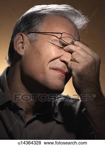 Tired man rubbing eyes View Large Photo Image Stock Photo - Tired man rubbing eyes. Fotosearch