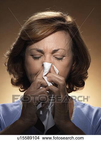Woman blowing nose View Large Photo Image Picture - Woman blowing nose. Fotosearch