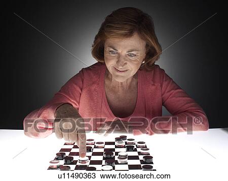Woman playing checkers View Large Photo Image Stock Image - Woman playing checkers. Fotosearch