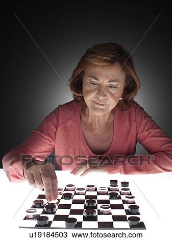 Woman playing checkers View Large Photo Image Stock Image - Woman playing checkers. Fotosearch