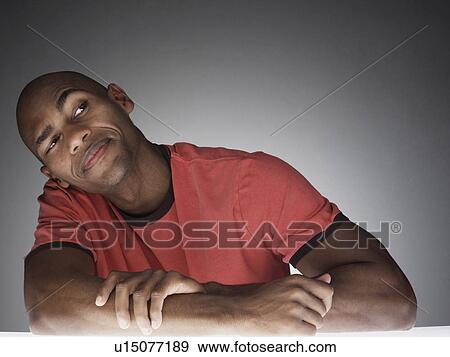 Young man looking and thinking (portrait) View Large Photo Image Stock Photo - Young man looking and thinking (portrait). Fotosearch
