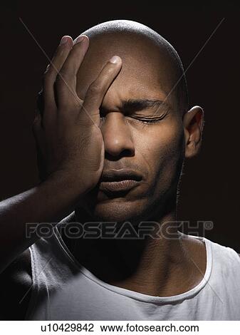 Young man with hand on face View Large Photo Image Stock Image - Young man with hand on face. Fotosearch