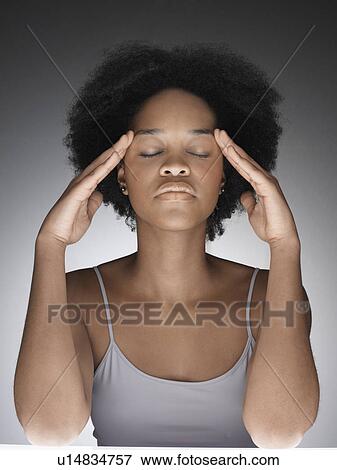 Stock Photo - Young woman thinking with hands on face. Fotosearch