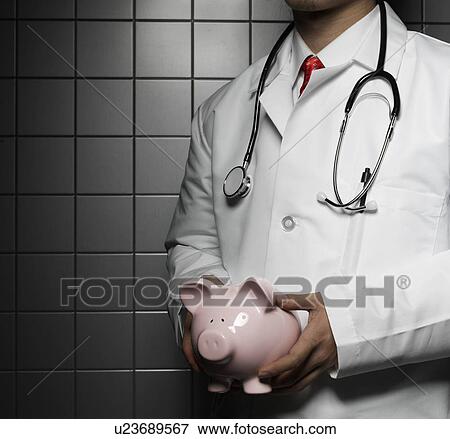 Doctor Holding Piggy Bank View Large Photo Image Stock Photo - Doctor Holding Piggy Bank. Fotosearch