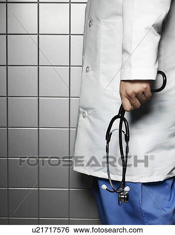 Stock Photograph - Doctor Holding Stethoscope. Fotosearch