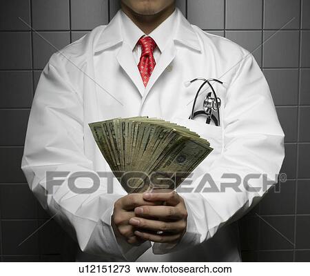 Stock Image - Doctor Holding US Dollars. Fotosearch