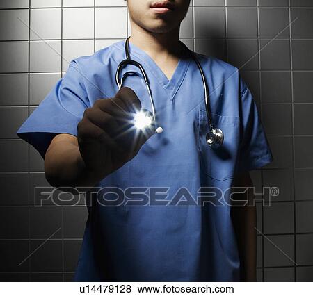 Stock Photo - Doctor with Stethoscope and Flashlight. Fotosearch