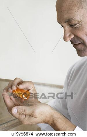 Picture - Mature man having medicine. Fotosearch